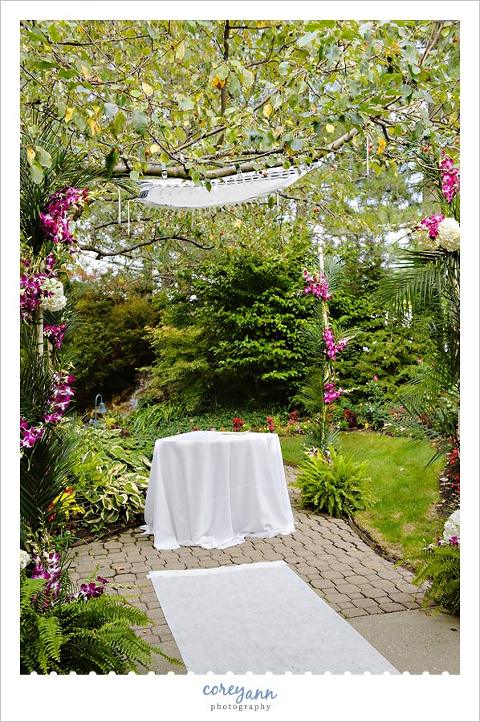 chuppah at landerhaven made with orchids and apple tree