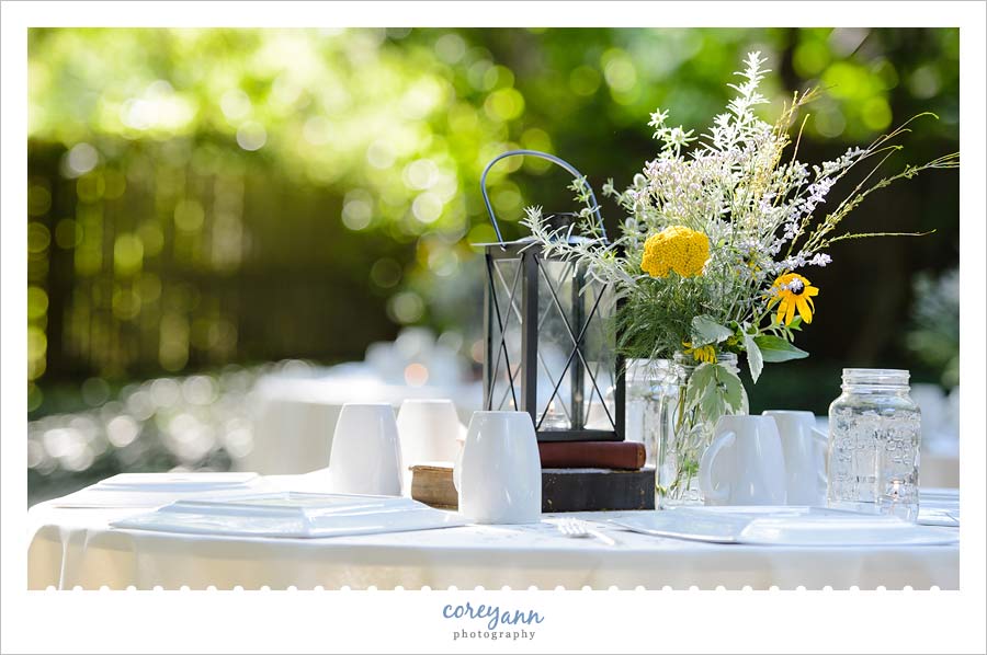book centerpieces and wildflowers at backyard wedding