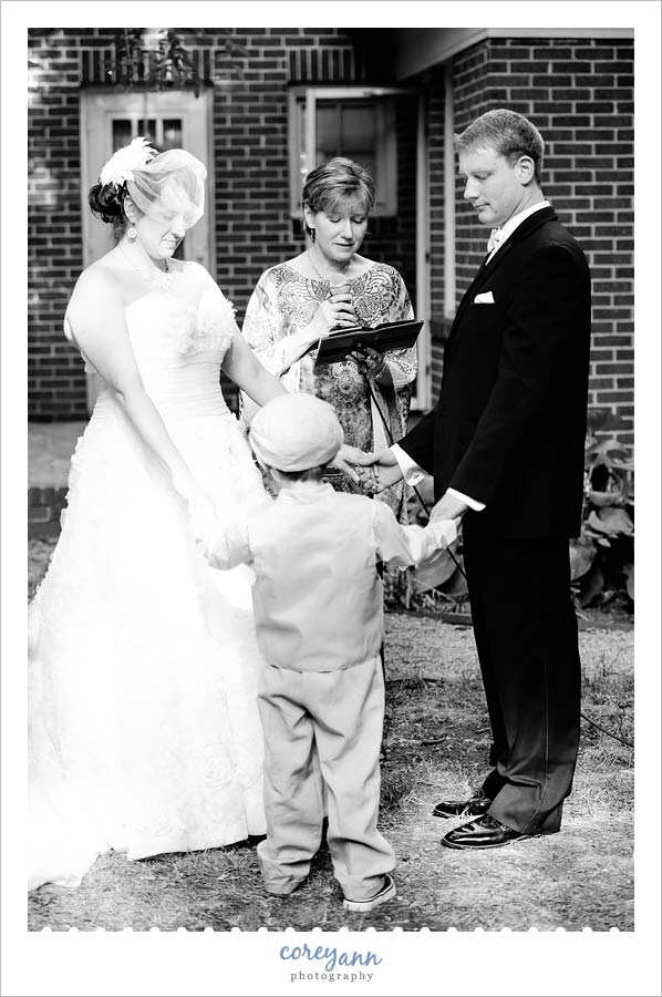 bride and groom including son in wedding ceremony
