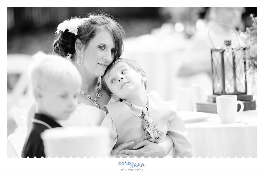 bride and son listening to poem being read during reception