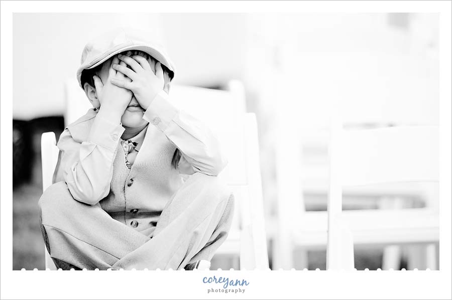 ring bearer covering up face to hide from photographer