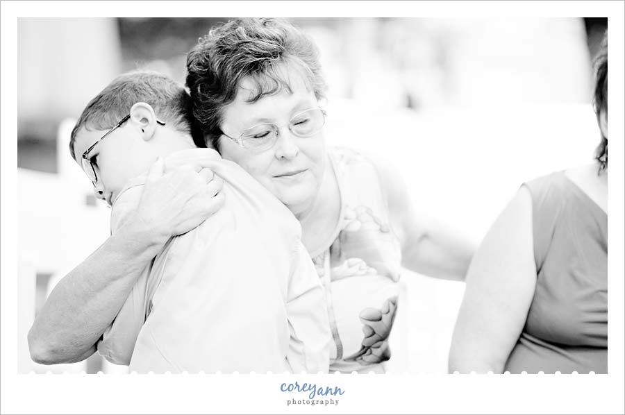 grandmother hugging grandson during wedding