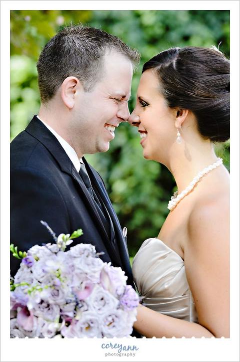 bride and groom touching noses and laughing