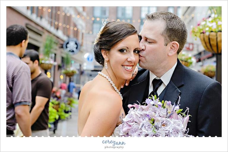 bride and groom kissing on east forth street in downtown cleveland