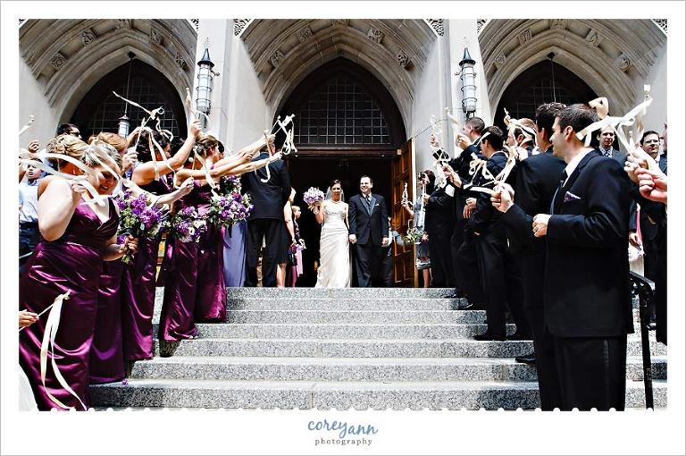 bride and groom exit from church with ribbon wands in cleveland ohio