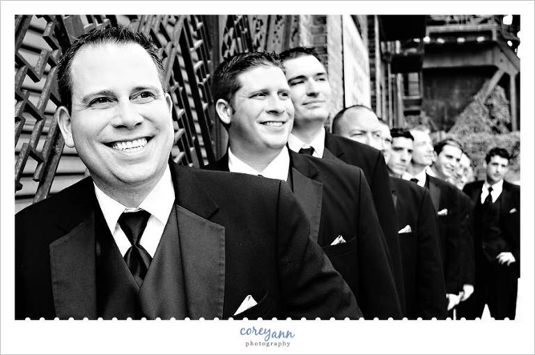 guys posing for groomsman picture in downtown cleveland