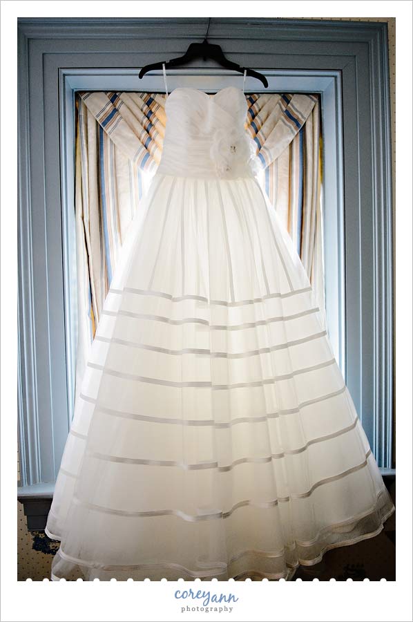 wedding dress hanging in window at Spread Eagle Tavern