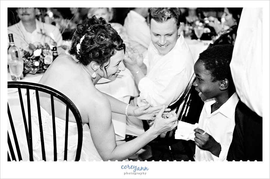 bride and groom hugging nephew after blessing