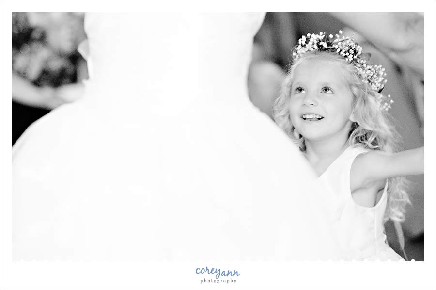 flower girl dancing with bride during wedding reception