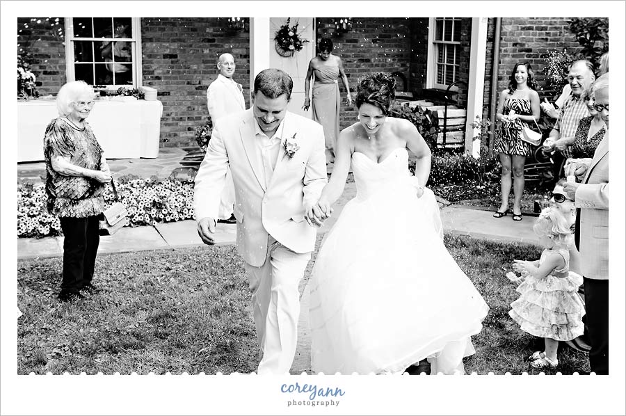 bride and groom exiting wedding ceremony with bubbles