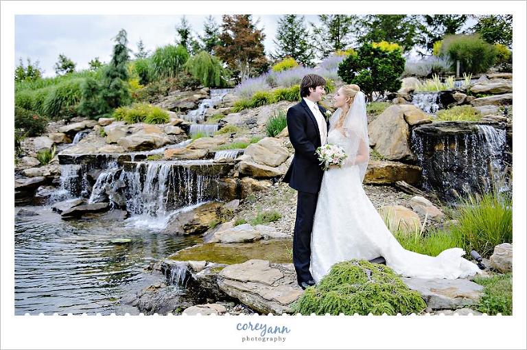 bride and groom in front of waterfalls