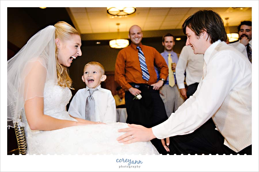 Jenny & John's Wedding ring bearer shocked during garter removal