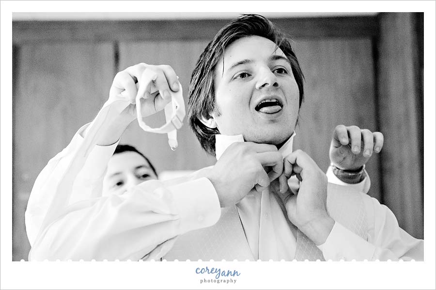 Jenny & John's Wedding groom getting ready and sticking tongue out