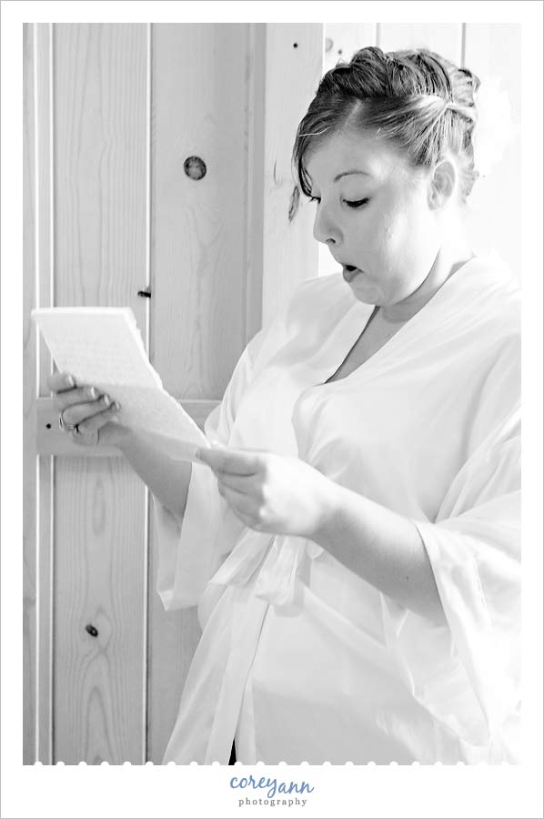 bride reading letter from groom before wedding