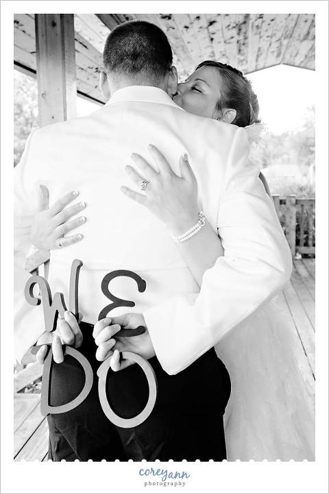 bride and groom holding we do letters