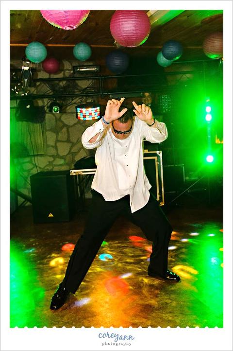 groomsman dancing on dance floor at wedding reception