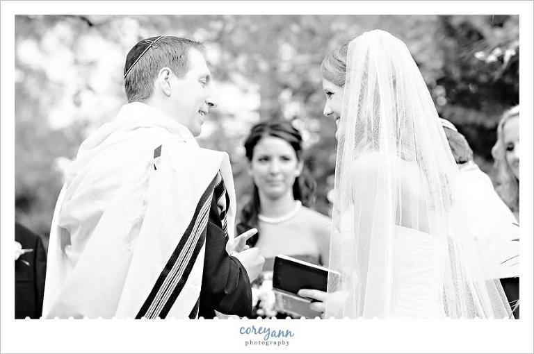 groom and bride smiling at each other during ceremony