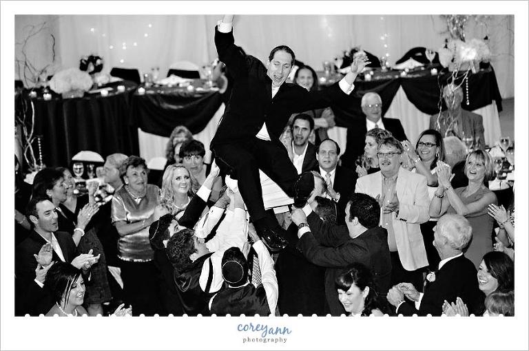 groom being thrown out of chair during the hora