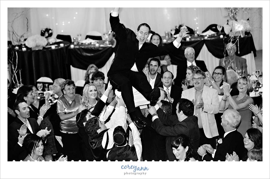 Stephanie and Mark's Wedding groom being thrown out of chair during the hora
