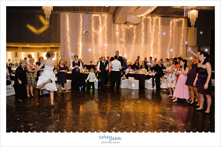 Stephanie and Mark's Wedding bride tossing the bouquet during reception at landerhaven