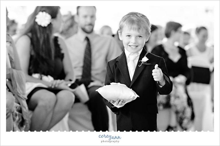 ring bearer giving a thumbs up during wedding processional