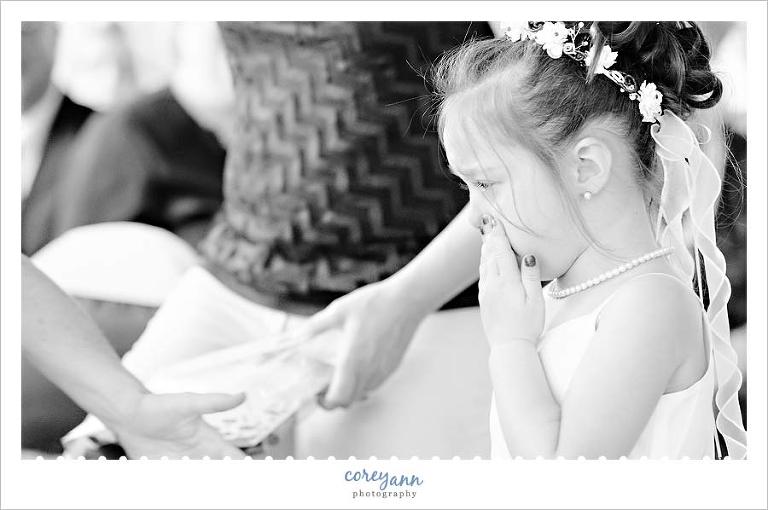 flower girl crying as she leaves the aisle