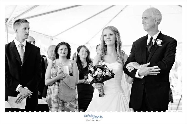 bride's father escorting bride down the aisle for wedding ceremony