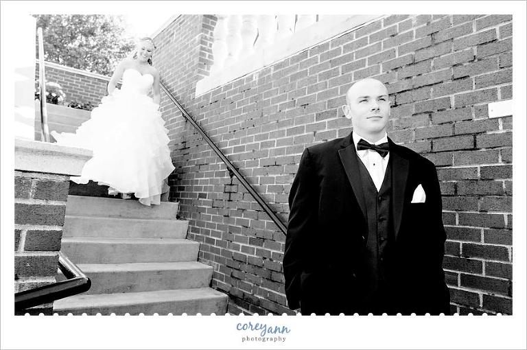 first look on stairs of bride and groom before wedding ceremony