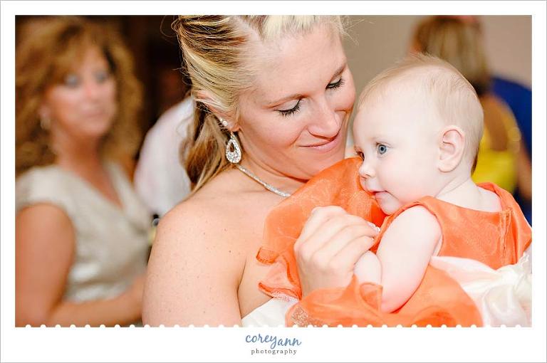 bride and baby daughter during wedding reception