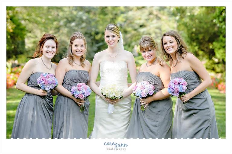 grey bridesmaid dresses with pink blue and purple bouqets