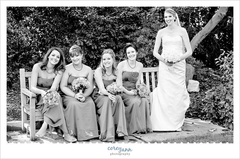 bride and bridesmaids near a tree in youngstown ohio