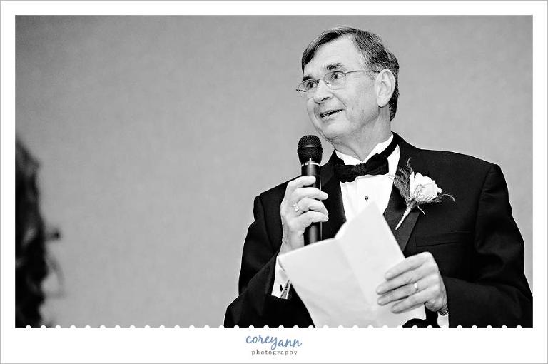father of bride welcoming guests with a toast during wedding reception