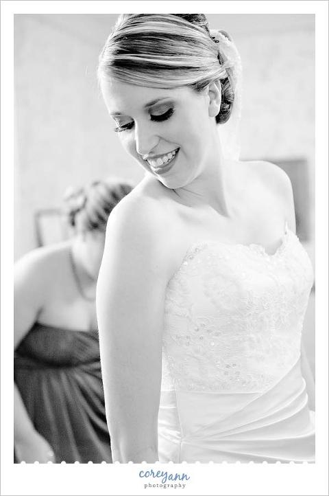 bride looking at her gown after getting dressed