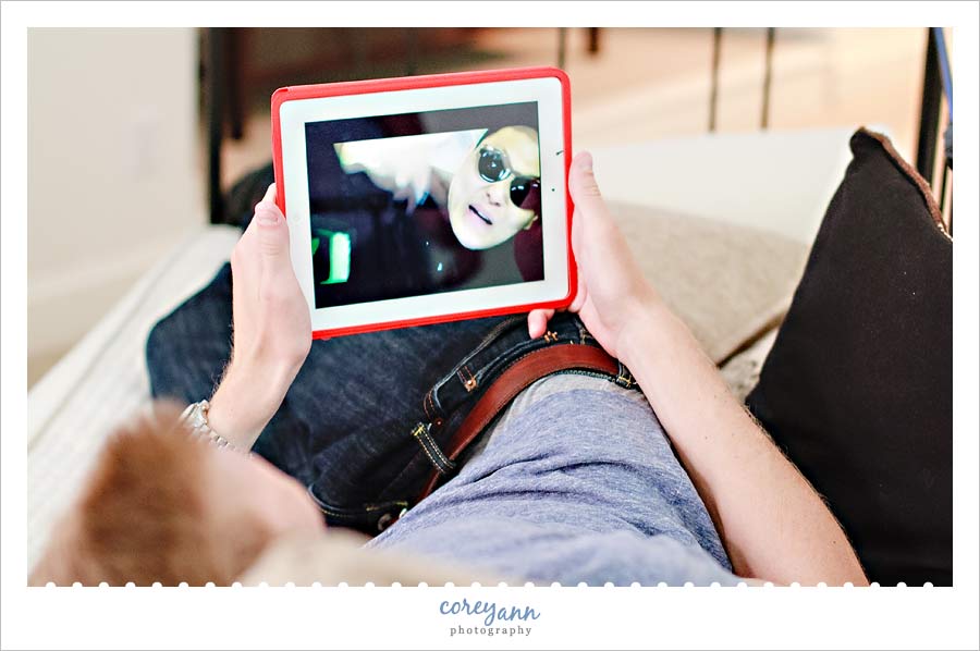 bride's wedding gown hanging from the curtain with a reflection in the mirror at The Club at Hillbrook