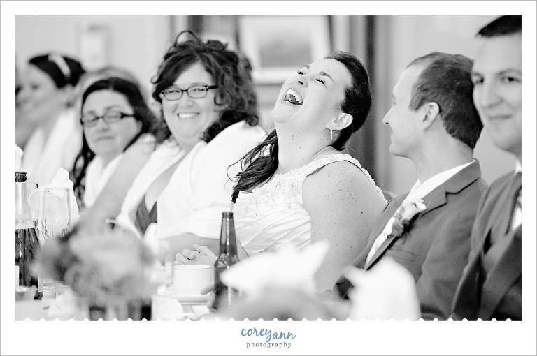 bride laughing during toast at reception at rose cafe