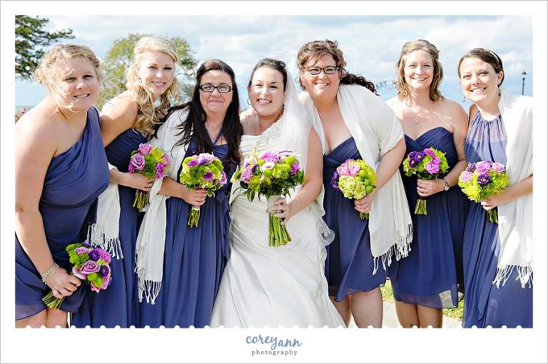 bridesmaids with pashimas in purple dresses with green and pink flowers