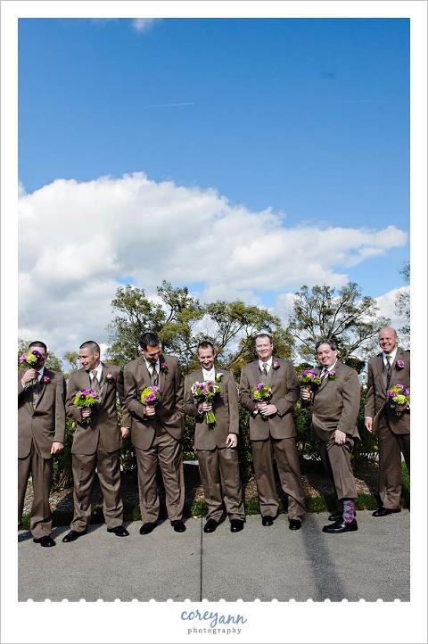 groomsman holding bouquets for wedding