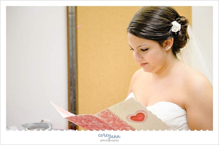bride reading a card from the groom before the ceremony