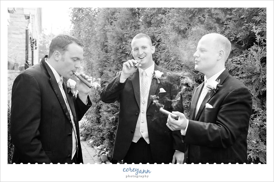groom and groomsman smoking cigars