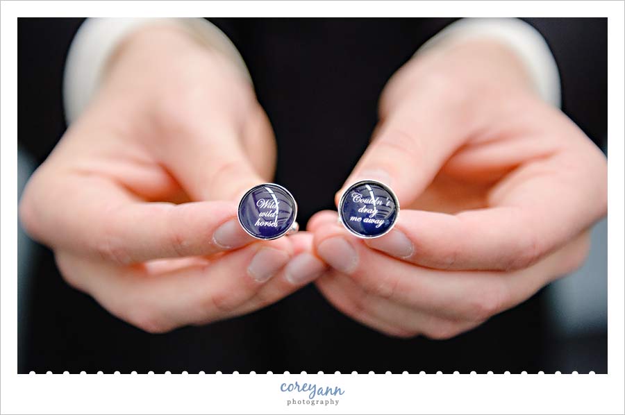 groom showing off custom cufflinks that were a gift from the bride
