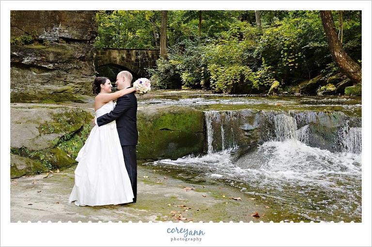 bride and groom kissing near waterfalls at fortier park in olmsted falls ohio