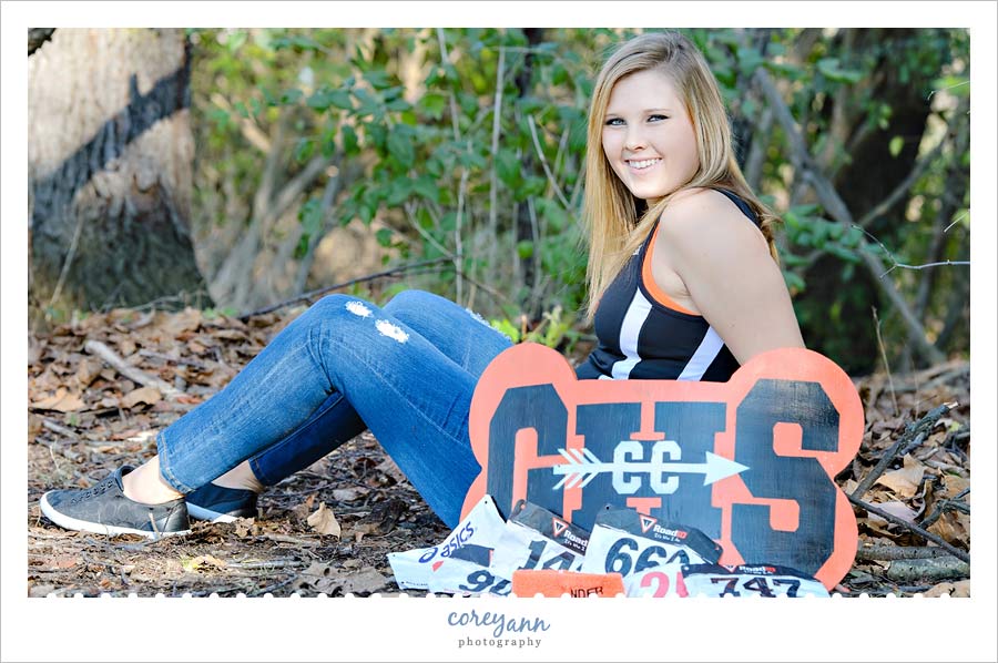 Erica's Senior Session senior picture with cross country sign and numbers