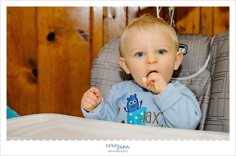 one year old boy before eating cake at his birthday party in ohio