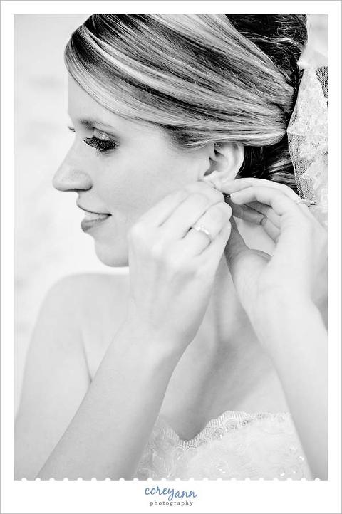 bride putting earring in her ear in Youngstown Ohio