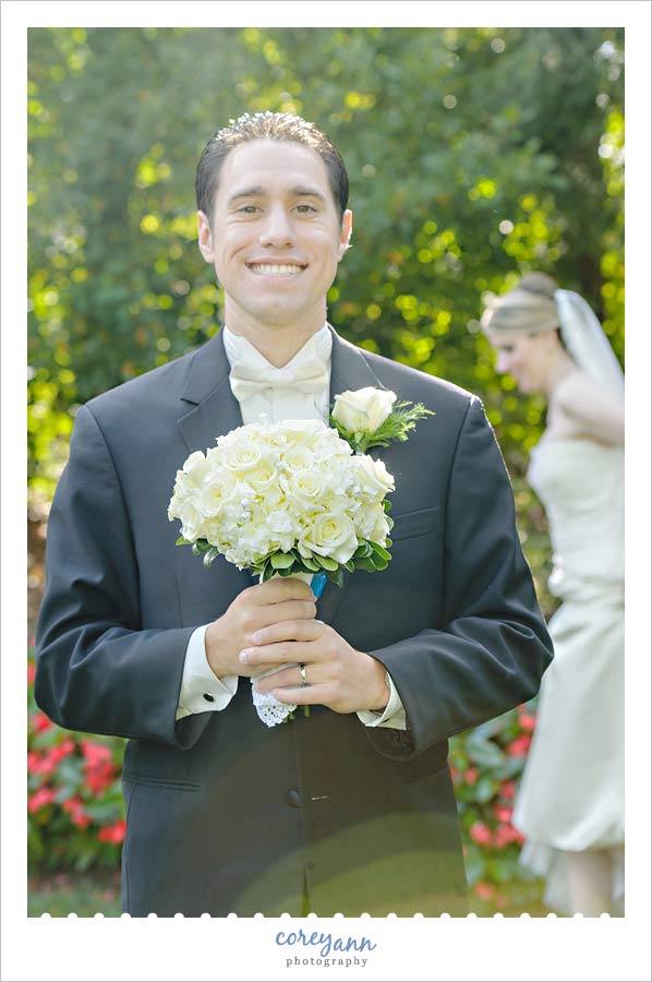groom holding bridal bouquet