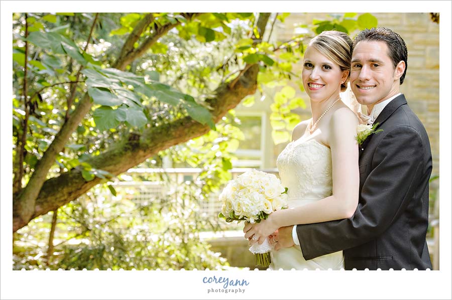 bride and groom in front of a tree in the afternoon