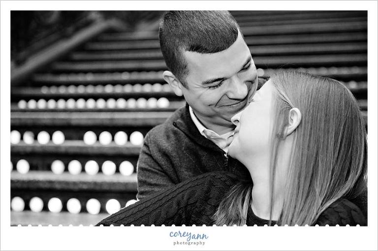 engagement session sitting on the lighted stairs at the hyatt arcade