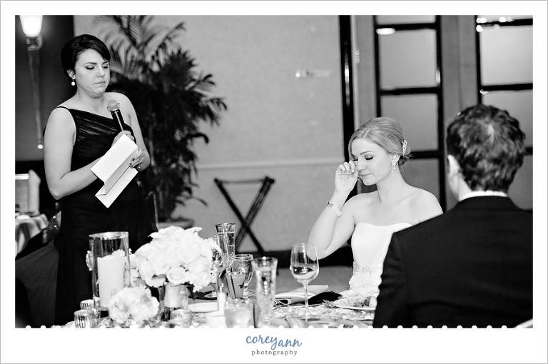 bride wiping away a tear during toast by her maid of honor in cleveland ohio