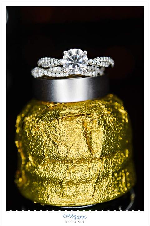 wedding rings on top of champagne bottle