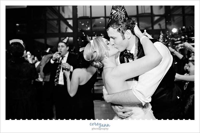 bride and groom kissing at midnight on new years eve during wedding at the club at key center